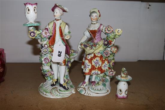 A pair of Derby candlestick figures of a gentleman and a lady, 24cm, damaged